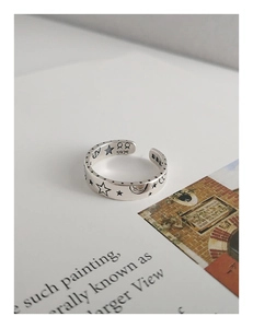 Close-up of S925 sterling silver ring showing star moon relief and purity stamp