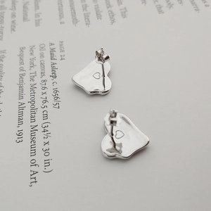 Detailed macro view of S925 sterling silver heart earrings with intricate cutout design