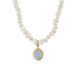 Baroque pearl necklace with oval gold pendant and moonstone charm on white background