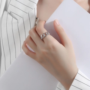 Close-up of minimalist S925 silver Cuban link chain ring on model finger