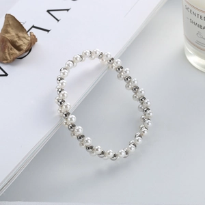 Close-up of double-layer beaded bracelet with white pearls and silver metal beads