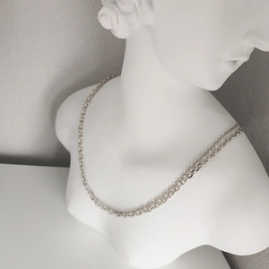 Polished S925 sterling silver double-layer chain necklace displayed on a white bust statue