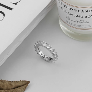 Detailed view of an S925 sterling silver eternity ring with zircon stones in a lifestyle set