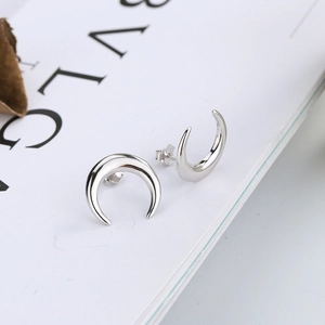 Detailed close-up of crescent moon stud earrings in polished 925 sterling silver