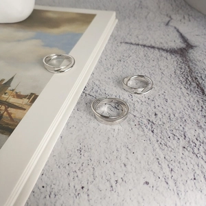 Detailed macro view of S925 sterling silver triple interlocking rings with metal stamps