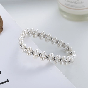 Detailed view of woven double-strand bracelet with white pearls and silver beads