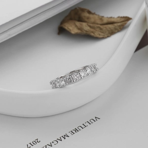 Macro detail of a silver S925 gear ring with sparkling pavé cubic zirconia accents