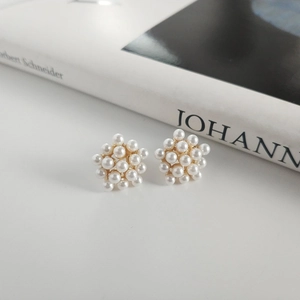Macro shot of 925 silver pearl cluster earrings on a clean white background