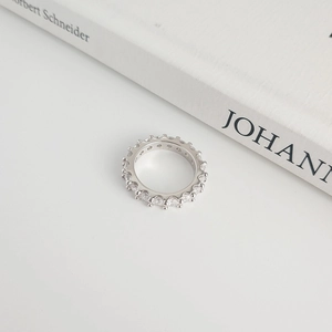 Macro shot of S925 sterling silver eternity band with sparkling cubic zirconia stones