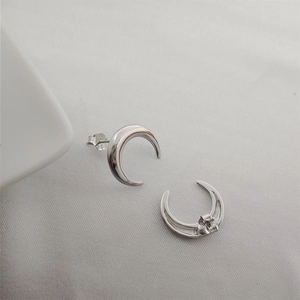 Macro detail of S925 sterling silver crescent moon stud earrings with silver hallmark