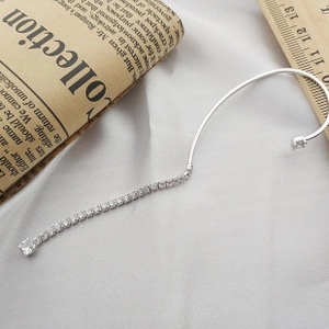 Detail of S925 sterling silver curved ear crawler with white cubic zirconia accents