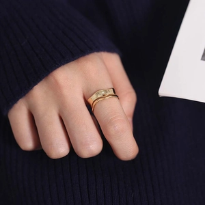 Elegant gold S925 sterling silver ring with minimalist wavy curve design on female finger