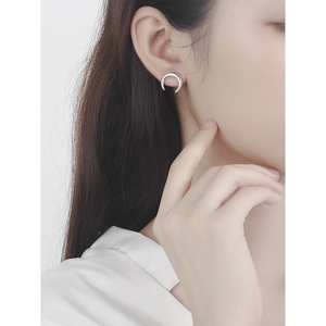 Minimalist S925 sterling silver crescent moon stud earrings shown on female model