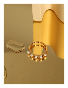 Detail of gold-plated silver ring with five pearls and textured vintage band details