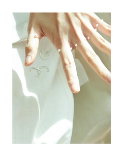 Close-up of elegant S925 silver smile rings with pearls worn on model's fingers