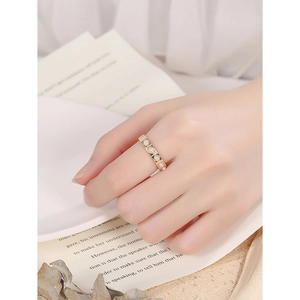 Minimalist S925 silver ring with pearls on vintage book background