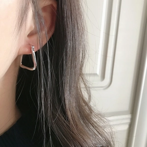 Minimalist S925 sterling silver geometric stud earrings worn by a model