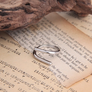 Close-up of S925 sterling silver minimalist wire ring with hallmark on vintage book pages