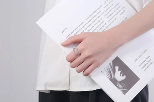 Close-up of a silver double-layered open ring for women with minimalist industrial design