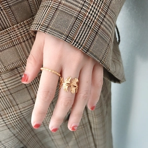 Elegant gold ginkgo leaf ring and twisted band on a hand with vintage style
