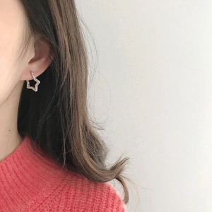 Close-up of elegant silver star hoop earrings with micro-pave cubic zirconia on a model