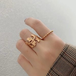Detail of S925 silver golden ginkgo leaf ring and twisted rope band worn on finger