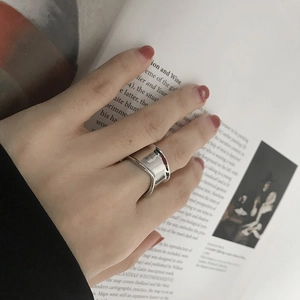 Minimalist wide S925 sterling silver ring with polished finish on model index finger