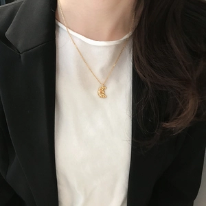 Minimalist S925 sterling silver croissant moon pendant necklace worn by a model in a suit