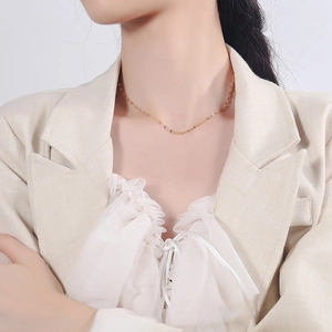 Elegant gold S925 sterling silver tile chain necklace on a model with a beige blazer