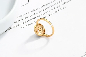 Macro detail of gold adjustable ring with honeycomb setting and sparkling zircon stone