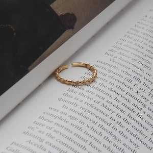 Macro detail of gold-plated S925 sterling silver twist ring showing S925 hallmark stamp