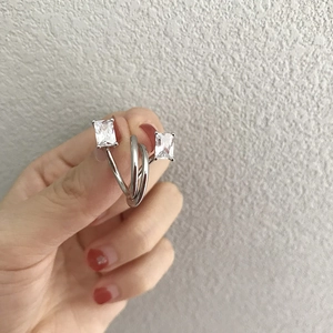 Macro shot of minimalist silver layered ring with rectangular zircon stones for women
