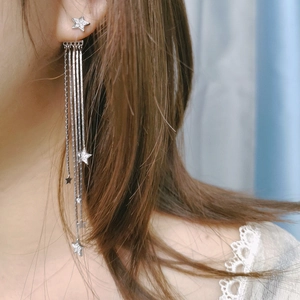 Close-up of star tassel earrings in S925 silver with sparkling zircon on model