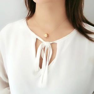 Minimalist S925 sterling silver gold necklace with rotating star-textured pendant on woman
