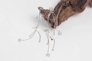 Detailed view of silver S925 sterling silver long tassel earrings with star zircon charms