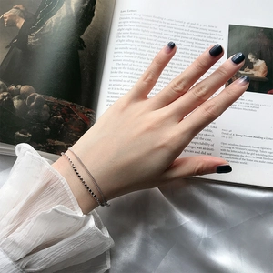 Minimalist double-layer S925 silver bracelet with flat beads on a model's wrist