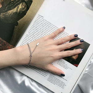 Detail of S925 sterling silver double-layer bracelet with flat beads on a female wrist