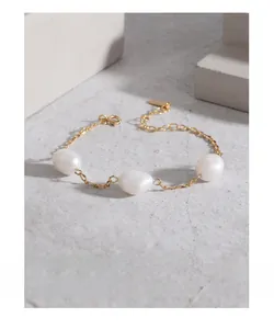 Detail of S925 silver bracelet with three baroque pearls and adjustable gold chain