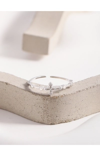 Vue macro de la bague ajustable en argent avec croix, textures cœur et micro-zircons
