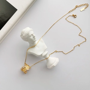 Macro shot of S925 sterling silver stamp on golden necklace with crystal pendant