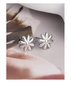 Macro view of S925 sterling silver daisy stud earrings with polished mirror finish