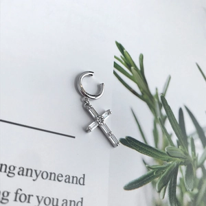 Detail of S925 sterling silver ear cuff featuring a baguette zircon cross pendant