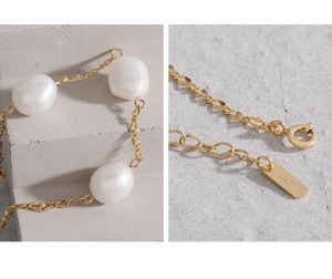 Close-up of S925 sterling silver stamp and baroque pearls on adjustable gold chain
