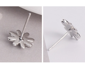 Close-up of S925 sterling silver daisy stud earrings with detailed hallmark stamp