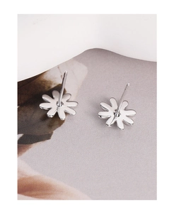 Macro view of minimalist S925 sterling silver daisy stud earrings with polished finish