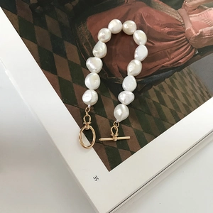 Detail of natural baroque pearls on 925 silver bracelet with golden OT toggle clasp