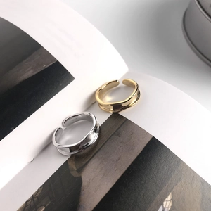 Detail of silver and gold S925 sterling silver open rings with minimalist wavy design