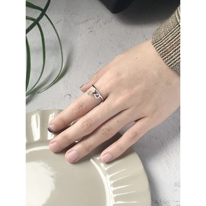 Elegante anello in argento S925 con zircone indossato sulla mano su un piatto