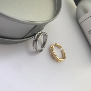 Detailed macro view of S925 hallmark on minimalist double-layered wavy silver ring