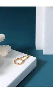 Detail of a minimalist gold ring featuring a mix of thick chain and fine mesh textures